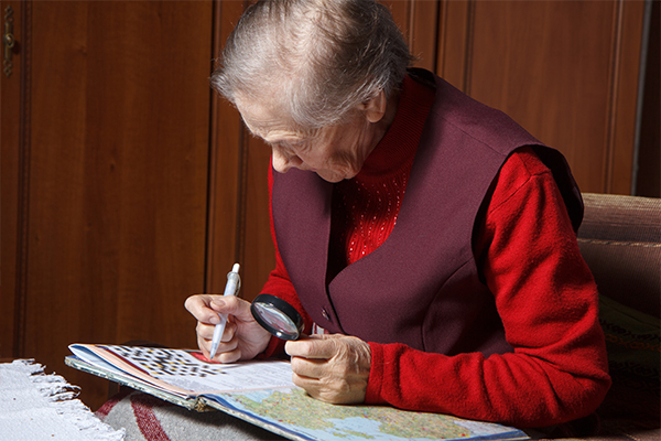 Senior woman solving a crossword puzzle